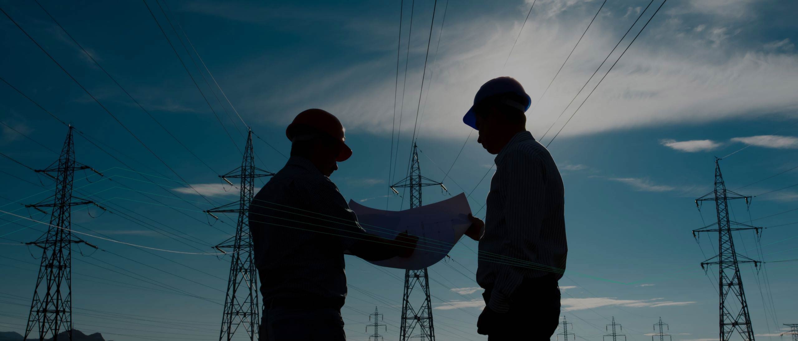 Two people wearing safety helmets examine a blueprint while standing in front of multiple electrical transmission towers under a blue sky, utilizing Adaptive Managed xDR for enhanced security measures.