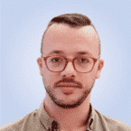  A person with short hair and glasses, embodying the essence of SecOps professionalism, is wearing a collared shirt against a light blue background.