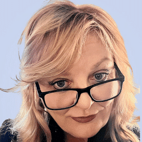  Person with blonde hair and glasses stands confidently against a light blue background, embodying the clarity and precision one might expect from a cutting-edge MDR solution.