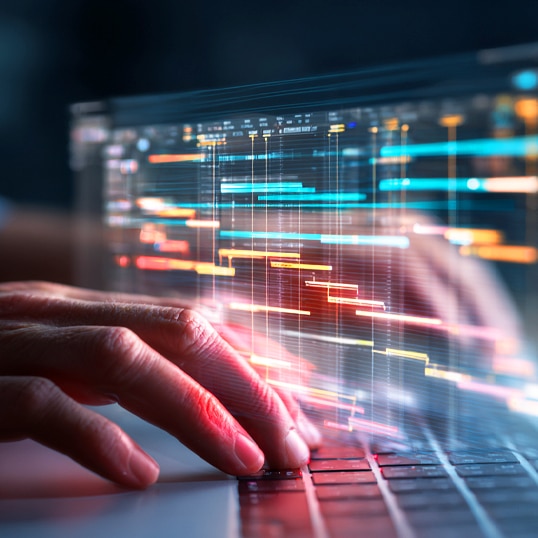  Close-up of hands typing on a laptop keyboard with colorful digital data charts and graphs superimposed on the screen, suggesting data analysis or programming to rationalize security and optimize security spend.